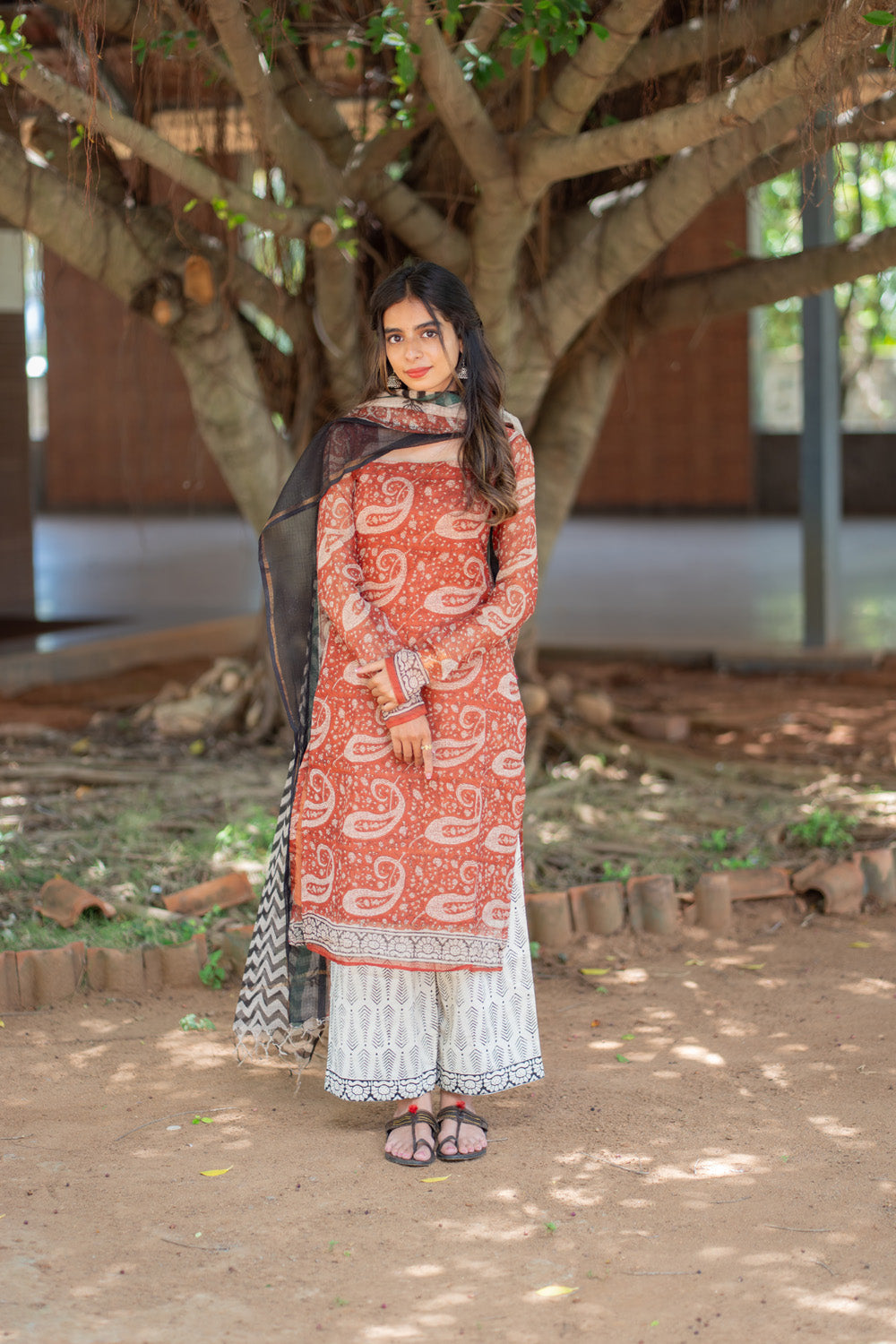 Vidya rust paisley suit set with dupatta draped on one shoulder