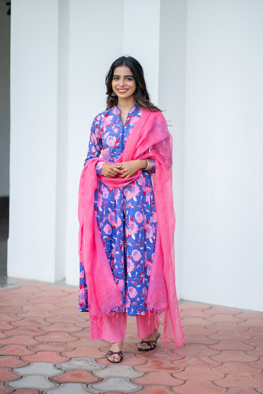 Oviya suit set with pink kota doria dupatta draped over both shoulders