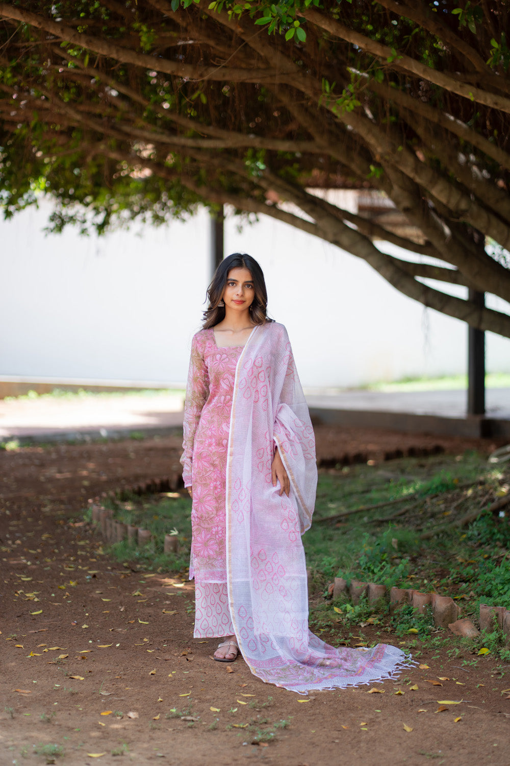 Rukmini pink suit set with printed kota doria dupatta draped on one shoulder